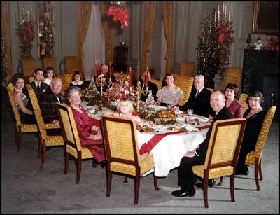 President and Mrs. Eisenhower are all smiles as they host a 1960 Christmas Party in the State Dining Room. 