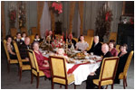 President and Mrs. Eisenhower are all smiles as they host a 1960 Christmas Party in the State Dining Room.