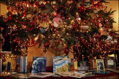 In addition to adorning the White House Christmas tree, decorations cover the mantle of the Blue Room.