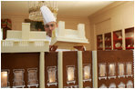 Thaddeus DuBois, Head Pastry Chef, places the roof on top of the White House gingerbread house.