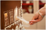 Thaddeus DuBois, Head Pastry Chef, adds finishing touches of sugar to the windows of the official White House gingerbread house.