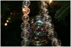 A shimmering glass decoration is seen on the White House Christmas Tree, a large Fraser Fir, in the Blue Room of the White House, Monday, Nov. 28, 2005.