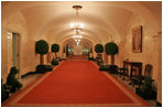 Topiary trees line the hallway of the Ground Floor of the White House residence.