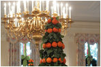 Two topiaries of lemon leaves and tangerines stand tall in the State Dining Room.