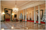 The North Portico of the White House opens up to the Cross Hall lined in fresh Boxwood Garland.