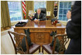 President Bush discusses the true meaning of the holidays with Barney and Miss Beazley in the Oval Office.