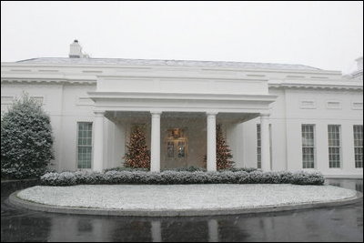 The glow of Christmas Trees guides the way to the West Wing Lobby during the season's first snow fall Monday, Dec. 5, 2005.