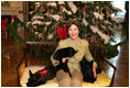 Mrs. Laura Bush poses with Barney, Miss Beazley and the family cat Willie, nicknamed “Kitty,” Friday, Dec. 1, 2006, next to the White House Christmas Tree in the Blue Room.