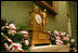 Red and white peppermint swirled candies accent the garland on the fireplace mantle in the Green Room.