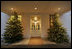 Sheltered from any possible winter snow beneath the West Wing lobby entrance, two trees glow with warm hospitality for all visitors this holiday season.