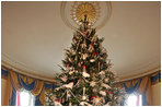 This year’s official White House Christmas Tree is a Douglas Fir donated by the Botek family, owners of The Crystal Spring Tree Farm in Lehighton, Pa. The 18-foot, 6-inch tree stretches from floor to ceiling in the Blue Room. The branches are topped with snow, accented with red ribbons and decorated with crystals and iridescent glass ornaments.