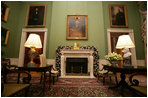 Red and white peppermint treats are hung on the garland on the mantle in the always seasonal Green Room. Approximately 1,089 feet of garland were used in decorating the White House this year.