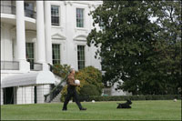 Barney leads the way as President George W. Bush carries Barney’s favorite soccer ball out to play on the South Lawn of the White House, Sunday, Nov. 25, 2007.