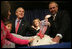 President George W. Bush invites children on stage, Tuesday, November 22, 2005, to pet "Marshmallow", the National Thanksgiving Turkey, at the official pardoning of the turkey at the Eisenhower Executive Office Building in Washington.