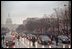 Thousands of spectators watch as the motorcade of newly inaugurated President George W. Bush drives along the parade route in Washington, D.C., Jan. 20, 2001. 