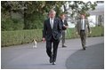 Followed closely by his dog Spot, President George W. Bush walks alone on the South Lawn March 19, 2004. In an address to the nation that evening, President Bush announced the start of Operation Iraqi Freedom.