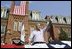 President George W. Bush waves to the estimated 3,000 people in attendance at an Independence Day celebration Monday, July 4, 2005, at West Virginia University in Morgantown. Said the President, "The history we celebrate today is a testament to the power of freedom to lift up a whole nation."