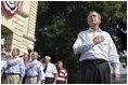 President George W. Bush joins war veterans on stage during the Pledge of Allegiance to open the "Saluting Our Veterans" Fourth of July Celebration in Ripley, West Virginia.