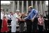 President George W. Bush greets the crowd at the Fourth of July Celebration on the steps of the Capitol in Charleston, West Virginia on Independence day, 2004.