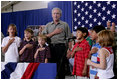 President George W. Bush joins a group of children during the Pledge of Allegiance Wednesday, July 4, 2007, at a Fourth of July visit with members of the West Virginia Air National Guard 167th Airlift Wing and their family members in Martinsburg, W. Va. White House photo by Chris Greenberg