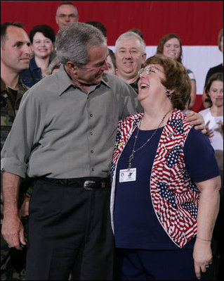 President George W. Bush embraces Joy Enders, president of the 167th Airlift Wing Family Readiness Group, Wednesday, July 4, 2007, during a Fourth of July visit with members of the West Virginia Air National Guard 167th Airlift Wing and their family members in Martinsburg, W. Va. President Bush thanked Enders and members of her organization for their mission to care for the families of deployed Guard members. White House photo by Chris Greenberg