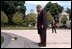 President George W. Bush and Laura Bush observe a moment of silence after laying flowers at the fountain by the entrance of Arlington National Cemetery May 28, 2001.