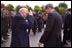 President George W. Bush salutes a veteran during a Memorial Day service at Notre Dame De La Paix Church at Normandy, France, May 27, 2002. The President and Mrs. Bush visited the beach and an American ceremony in honor of D-Day veterans.