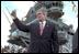 Addressing veterans, servicemen and women and families, President George W. Bush gives a thumbs-up during his speech marking the anniversary of Pearl Harbor on the U.S.S. Enterprise Dec. 7, 2001. "What happened at Pearl Harbor was the start of a long and terrible war for America. Yet, out of that surprise attack grew a steadfast resolve that made America freedom's defender. And that mission -- our great calling -- continues to this hour, as the brave men and women of our military fight the force of terror in Afghanistan and around the world," said the President.