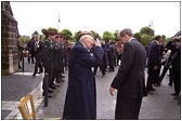 President George W. Bush salutes a veteran during a Memorial Day service at Notre Dame De La Paix Church at Normandy, France, May 27, 2002. The President and Mrs. Bush visited the beach and an American ceremony in honor of D-Day veterans.