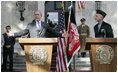 President George W. Bush gestures as he speaks during a press availability Wednesday, March 1, 2006, with Afghanistan President Hamid Karzai at the Presidential Palace in Kabul. "One of the messages I want to say to the people of Afghanistan," President Bush said, "is it's our country's pleasure and honor to be involved with the future of this country."