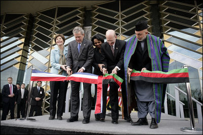 President George W. Bush and Afghanistan President Hamid Karzai, right, cut the ceremonial ribbon, Wednesday, March 1, 2006, to dedicate the new U.S. Embassy Building in Kabul, Afghanistan. President Bush is joined by Mrs. Laura Bush; U.S. Secretary of State Condoleezza Rice and U.S. Ambassador to Afghanistan Ronald E. Neumann.