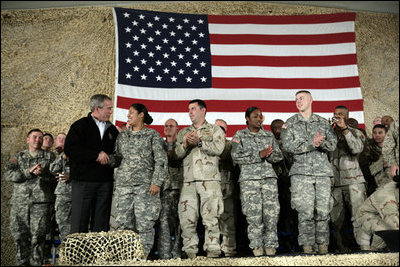 President George W. Bush meets and thanks a group of U.S. and Coalition troops, Wednesday, March 1, 2006, during a visit to Bagram Air Base in Afghanistan, where President Bush thanked the troops for their service in defense of freedom.