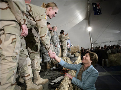 Mrs. Laura Bush greets U.S. and Coalition troops Wednesday, March 1, 2006, during a stopover at Bagram Air Base in Afghanistan, prior to the President and Mrs. Bush visiting India and Pakistan.