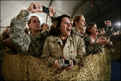 U.S. and Coalition troops cheer and take photos Wednesday, March 1, 2006, during an appearance by President George W. Bush and Mrs. Laura Bush at Bagram Air Base in Afghanistan.