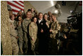 President George W. Bush poses for photos with U.S. and Coalition troops Wednesday, March 1, 2006, during a stopover at Bagram Air Base in Afghanistan, prior to his visit to India and Pakistan.