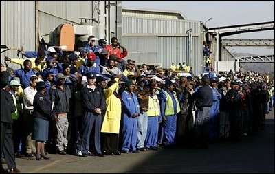 Workers at the Ford Motor Company plant watch as President Bush departs the plant near Pretoria, South Africa, Wednesday July 9, 2003. White House photo by Paul Morse