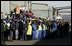 Workers at the Ford Motor Company plant watch as President Bush departs the plant near Pretoria, South Africa, Wednesday July 9, 2003. White House photo by Paul Morse