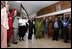 President George W. Bush, Mrs. Laura Bush, and to the President's right, Ugandan President Yoweri Museveni and Mrs. Museveni sing along with a choir and staff members of The AIDS Support Organization (TASO) Centre in Entebbe, Uganda Friday, July 11, 2003. White House photo by Susan Sterner