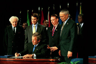 President Bush signs H.R. 1298, The U.S. Leadership Against HIV/AIDS Tuberculosis and Malaria Act of 2003, at the U.S. State Department May 27, 2003. Standing with the President are, from left, Representative Tom Lantos, D-Calif., Senator Bill Frist (R-Tenn., Secretary of Health and Human Services Tommy Thompson and Secretary of State Colin Powell.