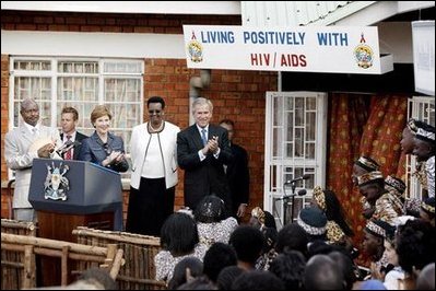 President George W. Bush and Mrs. Bush and President and Mrs. Musevni applaud the singing of the Watoto Choir at the TASO Centre in Entebbe, Uganda Friday, July 11, 2003.