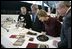 President George W. Bush and Laura Bush get a close look at some of the artifacts at the Canadian National Archives Gatineau Preservation Centre in Gatineau, Québec, Nov. 30, 2004. 