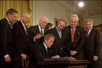 President George W. Bush signs the Patriot Act, Anti-Terrorism Legislation, in the East Room Oct. 26. 'With my signature, this law will give intelligence and law enforcement officials important new tools to fight a present danger,' said the President in his remarks. White House photo by Eric Draper. 