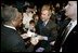 President George W. Bush greets audience members following a discussion on job training and the economy at Mesa Community College in Mesa, Arizona, Wednesday, Jan. 21, 2004.