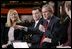 President George W. Bush speaks on stage during a conversation on the economy at SRC Automotive in Springfield, Mo., Monday, Feb. 9, 2004.