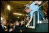 President George W. Bush takes a few moments to meet a few people during his visit to the BMW Manufacturing Corporation where he discussed jobs and the economy with employers and employees in Greer, S.C., Nov. 10, 2003.