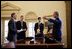 President George W. Bush meets with members of his National Economic Council in the Oval Office Feb. 10, 2004. From left, they are Director Stephen Friedman, Brain Reardon and Kevin Warsh. 