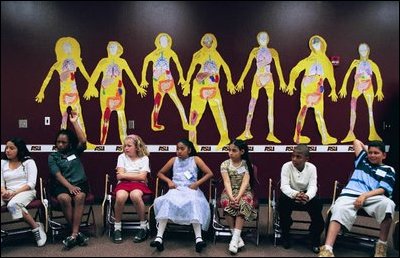 Children wait to meet Laura Bush during a visit to Maxine O. Bush Elementary School in Phoenix, Ariz., May 9, 2003. "Today in America, we have more students in school than ever before," said Mrs. Bush, who discussed the program, "Teach for America." "More children who want the American dream - and who undeniably deserve it. More than two million new teachers will be needed in America's classrooms in the next decade - and you can be one of them," she said.