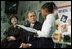 President Bush and Laura Bush listen to student Janea Bufford read at Moline Elementary School in St.Louis, Mo., Feb. 20, 2001. During his remarks, the President discussed the "Reading First" initiative, "It is a $5 billion program over five years. It will triple the amount of reading money available for local districts to access. It says that inherent in any good program is the need for districts to develop a K through 2 diagnostic tool; that is a simple tool that will enable K through 2 teachers to determine who needs help early."