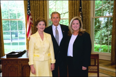 President George W. Bush and Laura Bush congratulate 2003 Maine Teacher of the Year Lorraine Johnson in the Oval Office Wednesday, April 30, 2003. White House Photo by Eric Draper