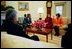 President George W. Bush talks with Idres Hawarry, Della Jaff and Dr. Katrin Michael, survivors of a chemical weapons attack in Halabja, Iraq, during a meeting in the Oval Office, March 14, 2003. Halbja is a Kurdish village in Northern Iraq where a chemical weapons attack killed 5, 000 people 15 years ago.